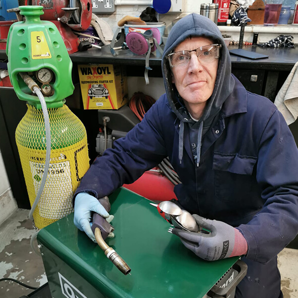 Darrell Olsen with his welder and a large bottle of Hobbyweld 5 rent free welding gas